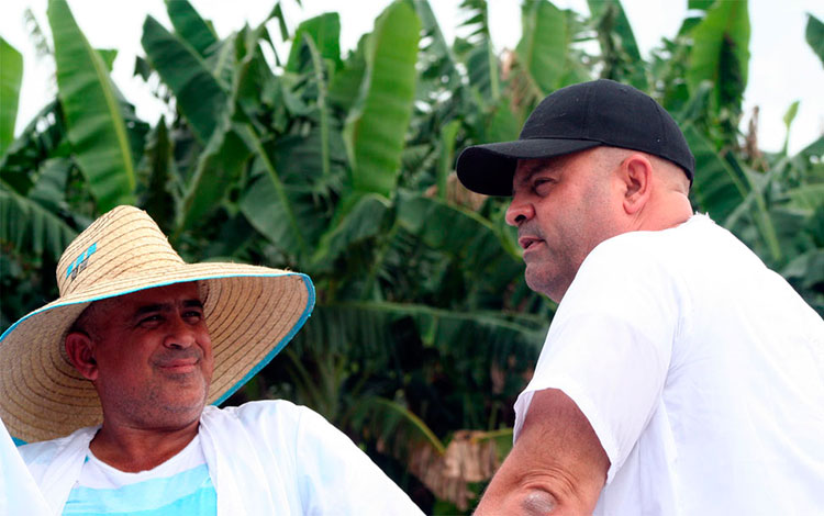 Porciultor Yudelsi Santos Suárez dialoga con el primer secretario del PCC en Villa Clara, Osnay Miguel Colina Rodrí­guez.