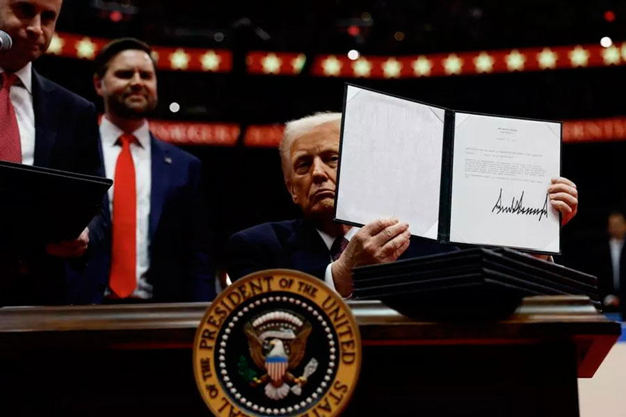 Donald Trump muestra la firma de órdenes ejecutivas en su primer día en la presidencia.