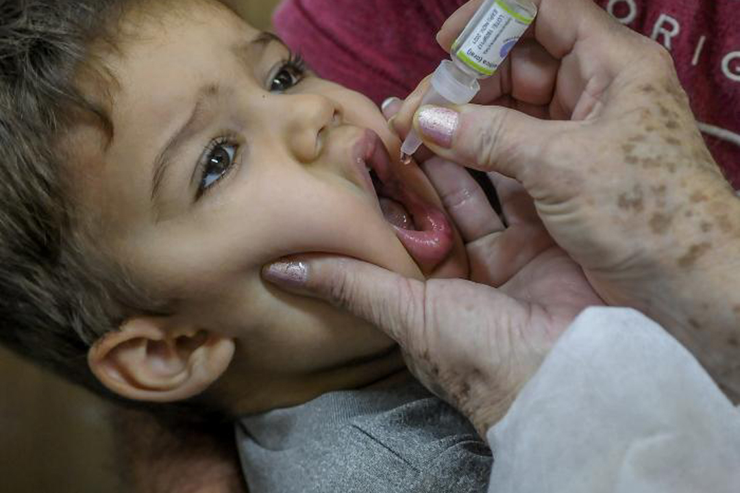 Enfermera aplicando dosis de vacuna a un niño